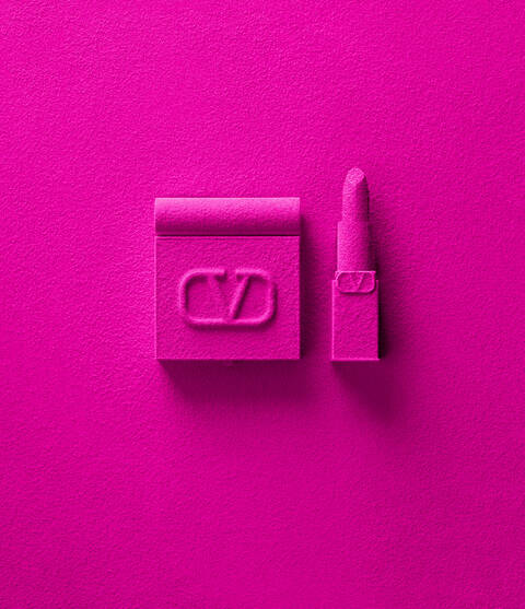 A vibrant pink background featuring a textured lipstick and a square lipstick case, both in the same shade of pink, with the letters "CVD" embossed on the case.